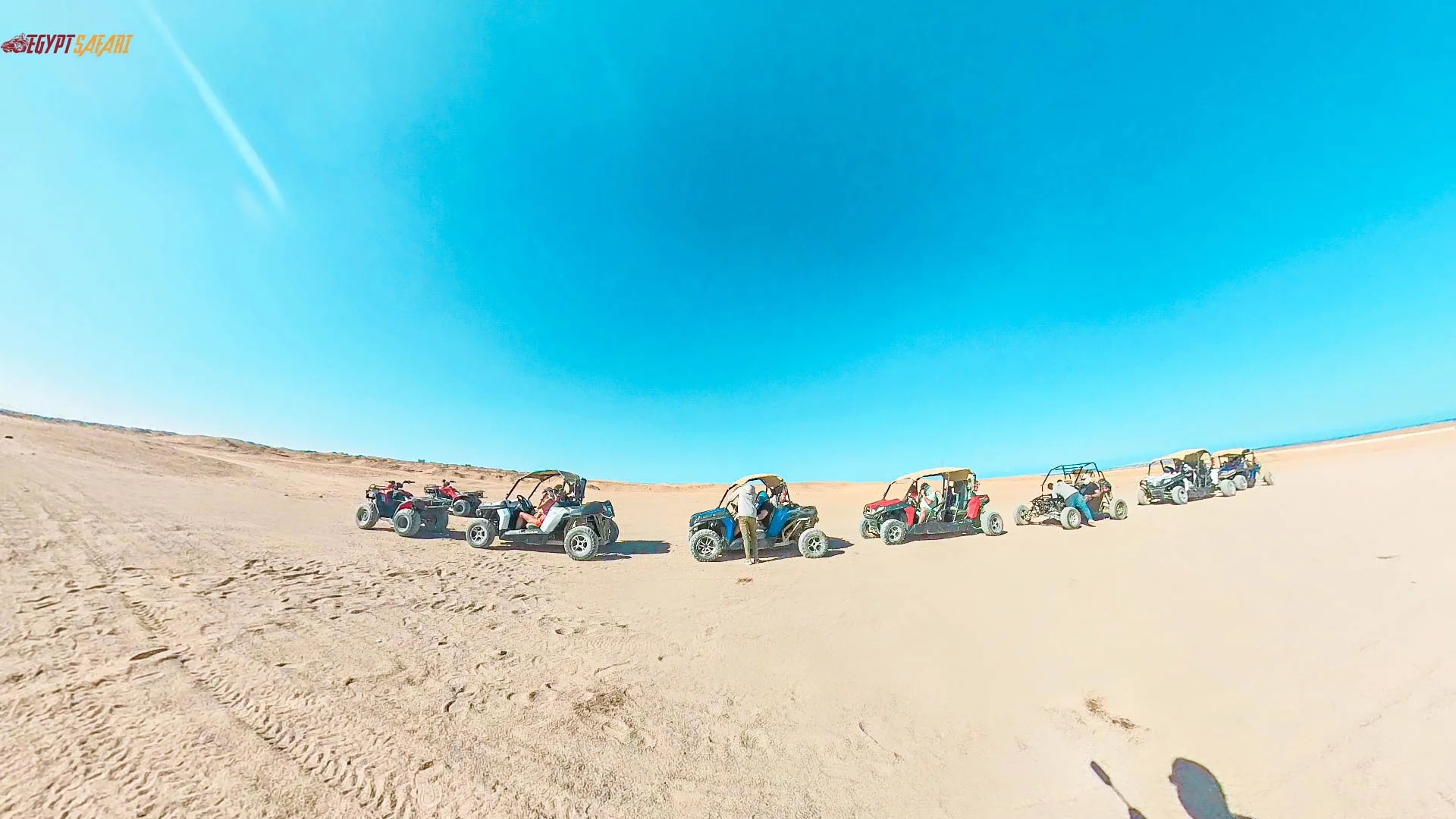 Quad bikes riding through the Egyptian desert at sunset